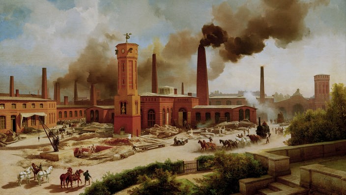 Großes Fabrikareal, im Hintergrund viele rauchende Schlote, dazwischen hohe Backsteinbauten, davor Stahlträger, Rohre, einzelne Pferdefuhrwerke.