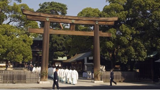 Shinto-Priester gehen durch das Tor des Meiji-Schreins in Tokio.
