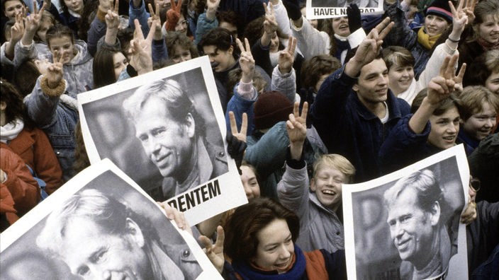 Demonstrierende Menschenmenge mit Vaclav-Havel-Plakaten.
