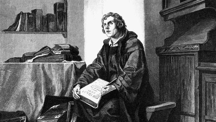 Die schwarz-weiße Xylografie eines Gemäldes von Wilhelm Lindenschmit zeigt den jungen Martin Luther beim Studium der Bibel. Er trägt ein Mönchsgewand und sitzt in einem Raum mit vielen Büchern.