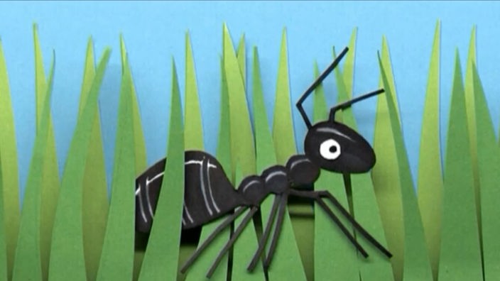 Eine gezeichnete Ameise im Gras.