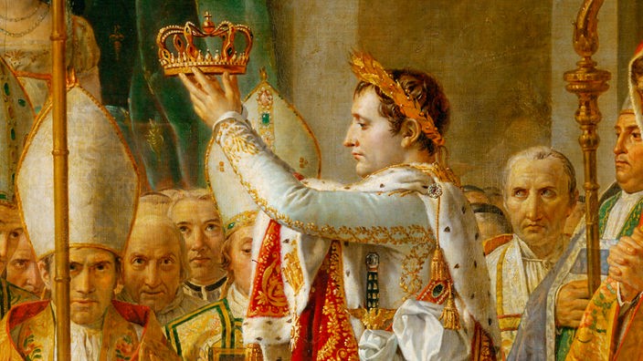 Auf diesem Gemälde sieht man Napoleon. Hier krönt er seine Gemahlin Josephine Beauharnais.