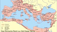 Die Grafik zeigt eine Europakarte mit Nordafrika. Das Römische Reich umfasst darin die nordafrikanische Küste von Gibraltar bis Ägypten, das heutige Israel, die Türkei, Griechenland, Italien, Spanien, Frankreich, das südliche und westliche Deutschland, Belgien, die Niederlande sowie Südengland.
