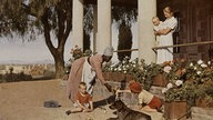 Weiße Mutter mit drei kleinen Kindern und afrikanischer Haushaltshilfe