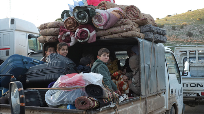 Kinder sitzen auf einem vollbepackten LKW an der türkisch-syrischen Grenze | Bildquelle: imago/Caro Kinder sitzen auf einem vollbepackten LKW an der türkisch-syrischen Grenze