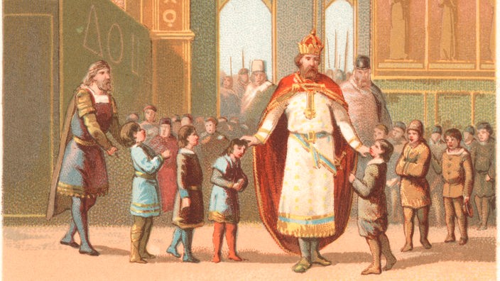 Auf dem historischen Bild ist Karl der Große von vielen Kindern umringt.