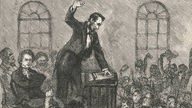Gemälde: Lincoln steht mit erhobener Hand an einem Rednerpult.