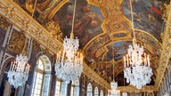 Spiegelsaal im Schloss Versailles mit Kronleuchtern und Deckenbemalung