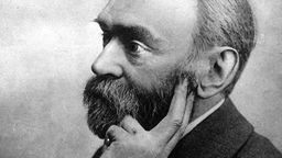 Schwarzweiß-Porträt von Alfred Nobel. Er trägt Vollbart.