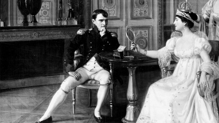 Napoleon Bonaparte und seine Frau Joséphine sitzen in einem eleganten Wohnraum | Bildquelle: picture alliance / TopFoto Napoleon Bonaparte und seine Frau Joséphine sitzen in einem eleganten Wohnraum