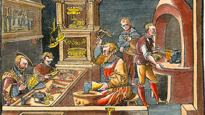 Der Holzschnitt zeigt die mittelalterliche Werkstatt eines Goldschmieds; mehrere Personen fertigen unterschiedliche Teile eines Schmiedeerzeugnisses an.