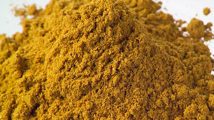 Currypulver auf einem Teller. | Bildquelle: picture alliance Currypulver auf einem Teller.