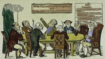 Karikatur zu den Karlsbader Beschlüssen. Menschen sitzen mit zugebundenen Mündern an einem Tisch.