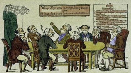 Karikatur zu den Karlsbader Beschlüssen. Menschen sitzen mit zugebundenen Mündern an einem Tisch. | Bildquelle: akg Karikatur zu den Karlsbader Beschlüssen. Menschen sitzen mit zugebundenen Mündern an einem Tisch.