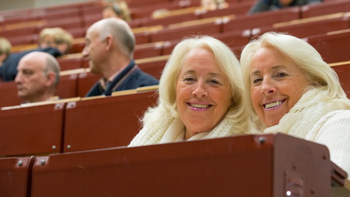 Eineiige Zwillingsdamen sitzen im Hörsaal der Universität Bielefeld