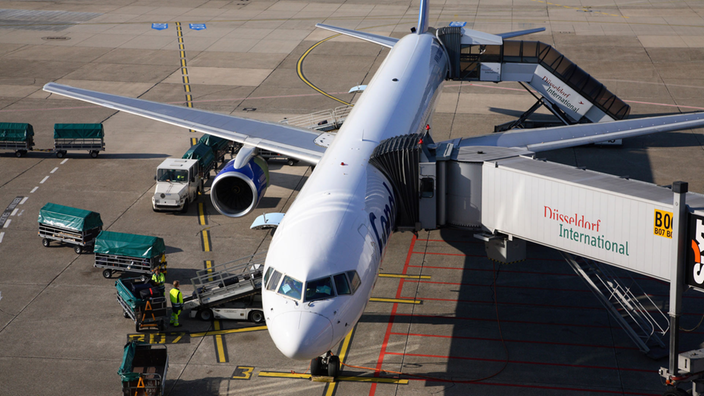Ein Flugzeug der Condor, Boeing 737, wird vom Bodenpersonal mit dem Gepäck der Passagiere beladen.