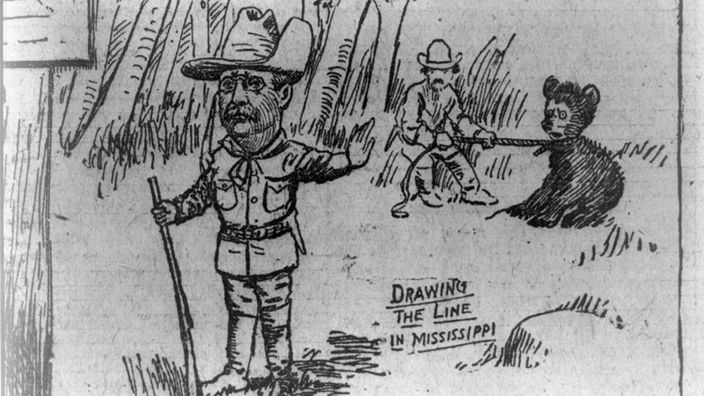 Karikatur: US-Präsident Roosevelt mit Gewehr weigert sich, einen gefangenen Bären zu erschießen. Daneben steht der Satz "Drawing the Line in Mississippi"