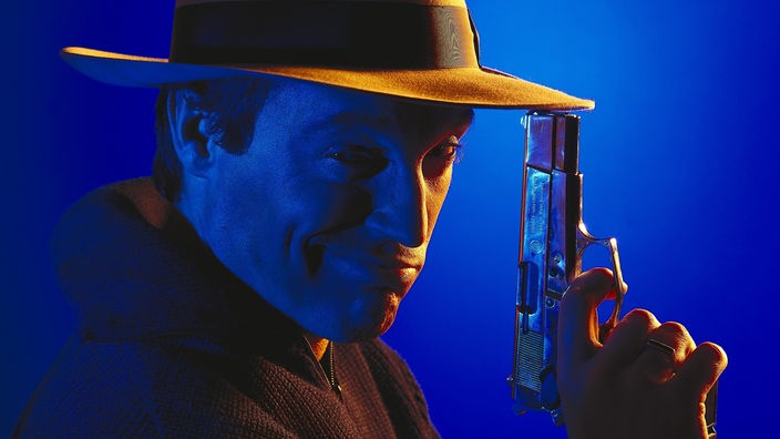 Ein Mann mit Hut und Pistole