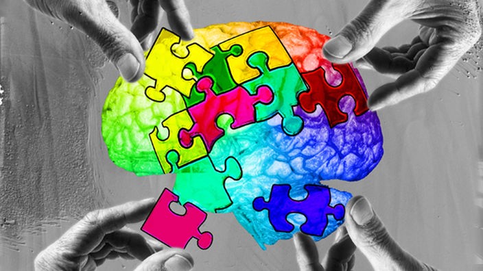 Vier Hände setzen Puzzleteile in ein Gehirn