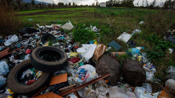 Neben einem bestellten Feld in der Nähe von Neapel stapelt sich Müll.