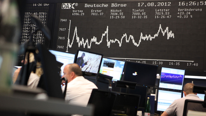 Händler arbeiten unter der Kurve des Deutschen Aktenindexes in der Börse in Frankfurt am Main