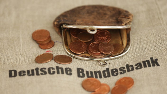 Geldbeutel mit Münzen lieget auf Tuch mit Aufrschrift Deutsche Bundebank
