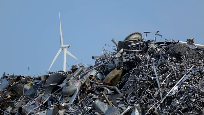 Berg von Altmetall vor einem Windrad | Bildquelle: imago Berg von Altmetall vor einem Windrad