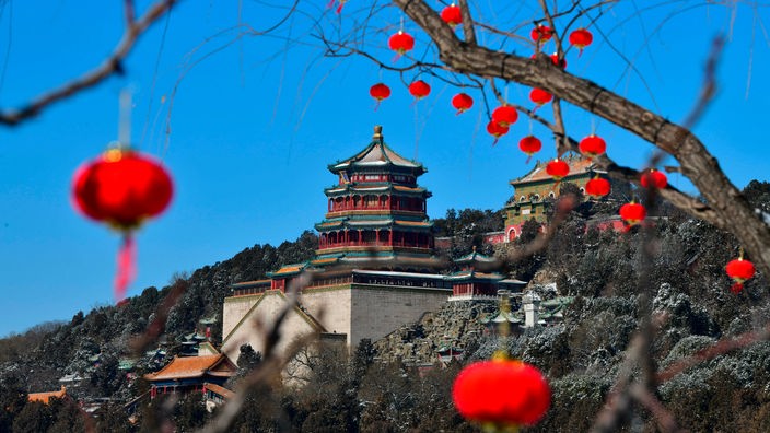 Der Sommerpalast in Peking, im Vordergrund ein Ast mit kleinen roten Lampions