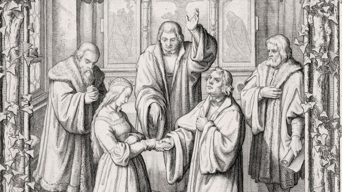 Stich von der Hochzeit Luthers mit Katharina von Bora. Die beiden knieen sich gegenüber vor einem Altar. Rechts hinter den Brautleuten steht jeweils ein betender Zeuge. Ein Priester segnte gerade die Ehe.