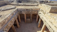 Blick von oben auf eine archäologische Ausgrabungsstätte mit Mauern und Säulen