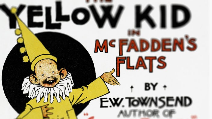 Abbildung der Comicfigur Yellow Kid – ein kleines kahlköpfiges Kind mit Segelohren in einem gelben Nachthemd.