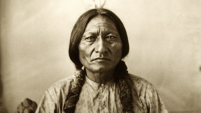 Porträt von "Sitting Bull", dem Medizinmann der Hunkpapa Lakota Sioux, um 1884. Der Indianer trägt einen kleinen Federschmuck und blickt aufrecht in die Kamera. 