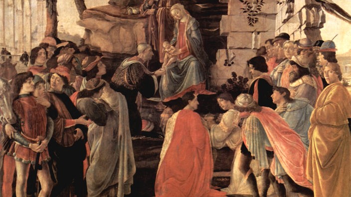 Gemälde von Botticelli: Zahlreiche Personen stehen vor der Krippe des Jesuskindes und machen ihm seine Aufwartung in Gewändern des 15. Jahrhunderts.