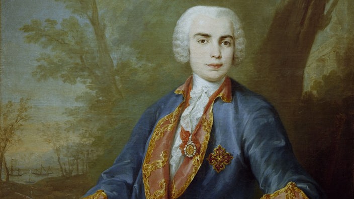 Das Bild zeigt ein Farinelli-Porträt, auf dem der Kastrat im Barockgewand und mit weißer Perücke zu sehen ist.