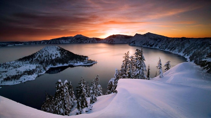 Insel in einem Kratersee vor untergehender Sonne