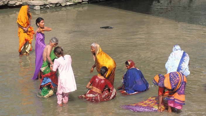 Eine Gruppe von Frauen wäscht sich im Fluss