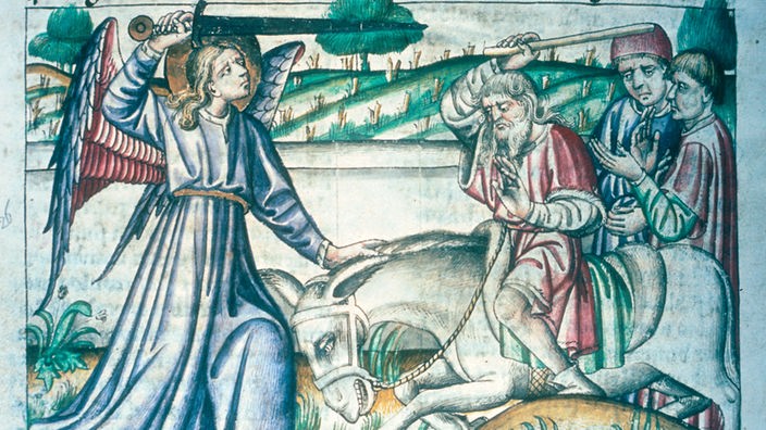 Buchdruck: Ein Mann schlägt einen Esel mit einem Stock. Der Esel wird von einem Engel mit Schwert aufgehalten