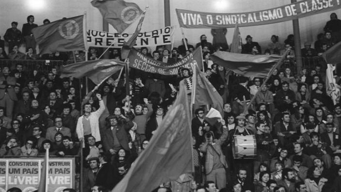 Anhänger der Sozialistischen Partei mit Fahnen und Transparenten auf einer Tribüne bei einer Wahlversammlung in Lissabon.