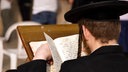 Orthodoxe Juden beten vor der Klagemauer in Jerusalem und studieren dabei Gebetsbücher