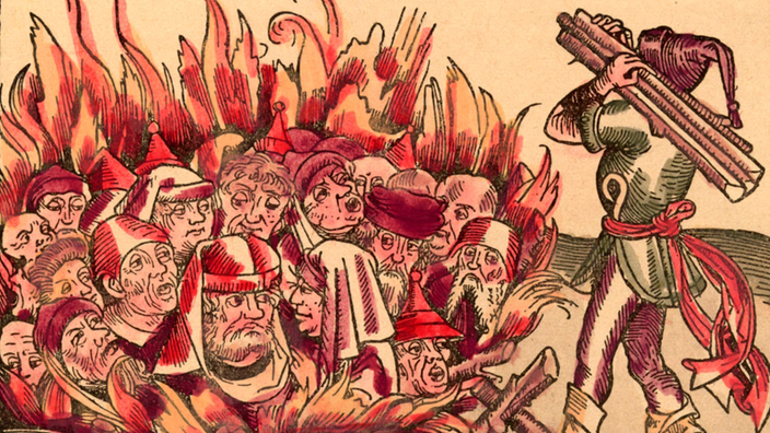 Zeichnung: Mehrere Menschen werden auf einem Scheiterhaufen verbrannt. Ein Mann legt noch Holz nach.