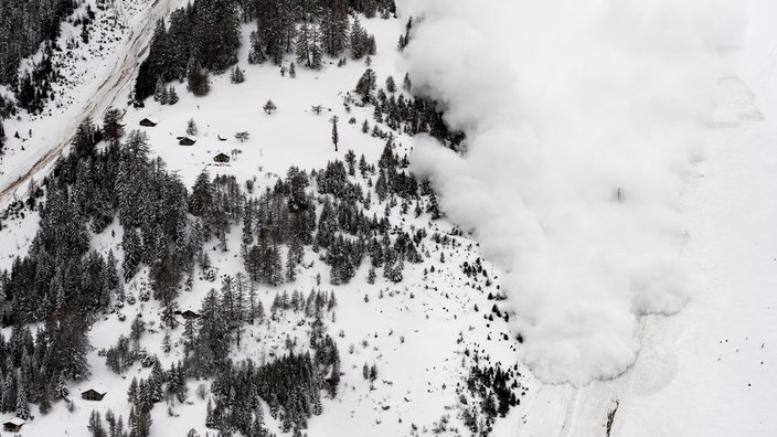 Die Luftaufnahme zeigt, wie Schneemassen einen Berg hinunterrollen | Bildquelle: dpa/Jean-Christophe Bott Die Luftaufnahme zeigt, wie Schneemassen einen Berg hinunterrollen