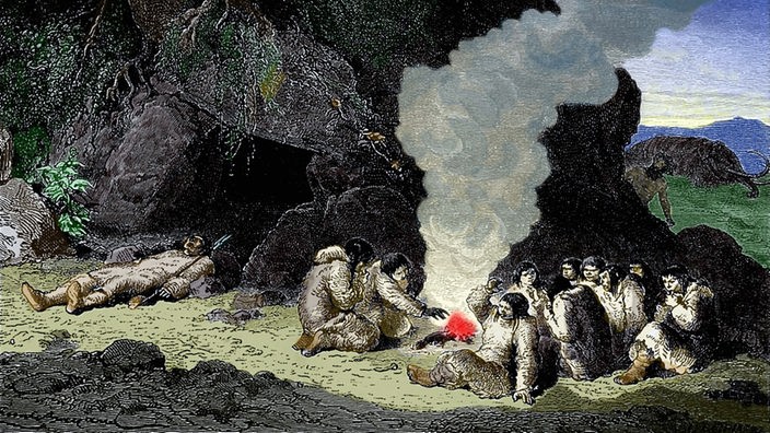 Illustration Altsteinzeit: Höhlenmenschen sitzen um eine Feuerstelle vor ihrer Höhle und essen (Stich von 1870)