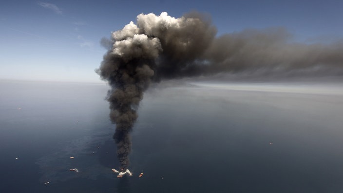 Luftannahme: Boote an brennender Ölplattform | Bildquelle: AP/Gerald Herbert Luftannahme: Boote an brennender Ölplattform
