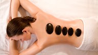 Junge Frau bekommt eine Hot-Stone-Massage