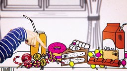 Eine echte Hand zeigt auf gezeichnete Süßspeisen, die auf einem Tisch stehen.