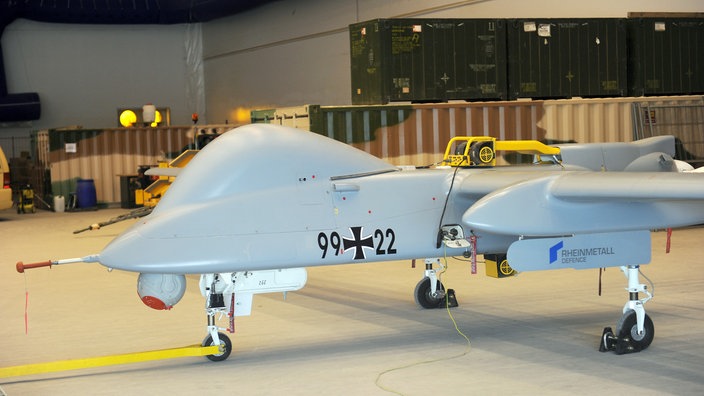 Eine Kampfdrohne des Typs Heron steht in einer Logistikhalle | Bildquelle: dpa Eine Kampfdrohne des Typs Heron steht in einer Logistikhalle