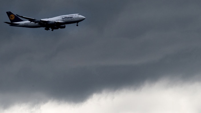 Ein Jumbojet vor dunklen Wolken