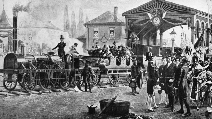 Schwarzweiß-Lithographie: Eine Menschenmenge hat sich um einen Zug versammelt | Bildquelle: akg Schwarzweiß-Lithographie: Eine Menschenmenge hat sich um einen Zug versammelt