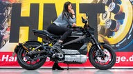 Ein Model posiert auf einem Elektro-Motorrad der Firma Harley-Davidson