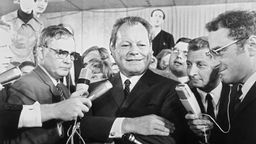 Willy Brandt lächelt am Wahlabend 1969 in die Kameras
